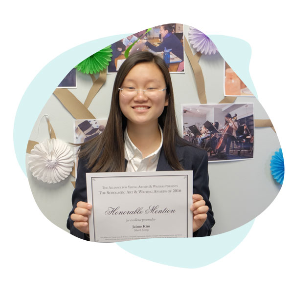 Student posing with award